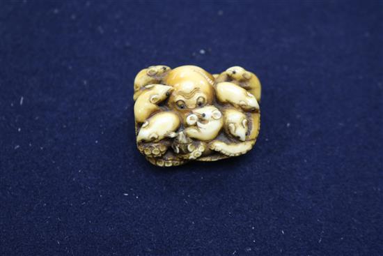 Four Japanese ivory netsuke, an okimono, an octopus and rats, a shi-shi maiju type netsuke, and two figure groups